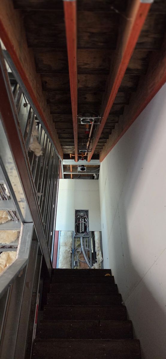 Beam ceiling over a finished stairwell landing.