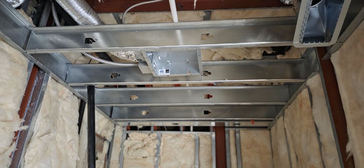 Suspended ceiling grid framed around ductwork.