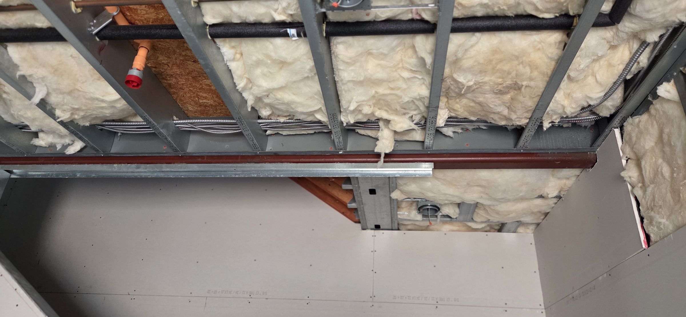 Ceiling framed and boarded, edges cut tight to the framing