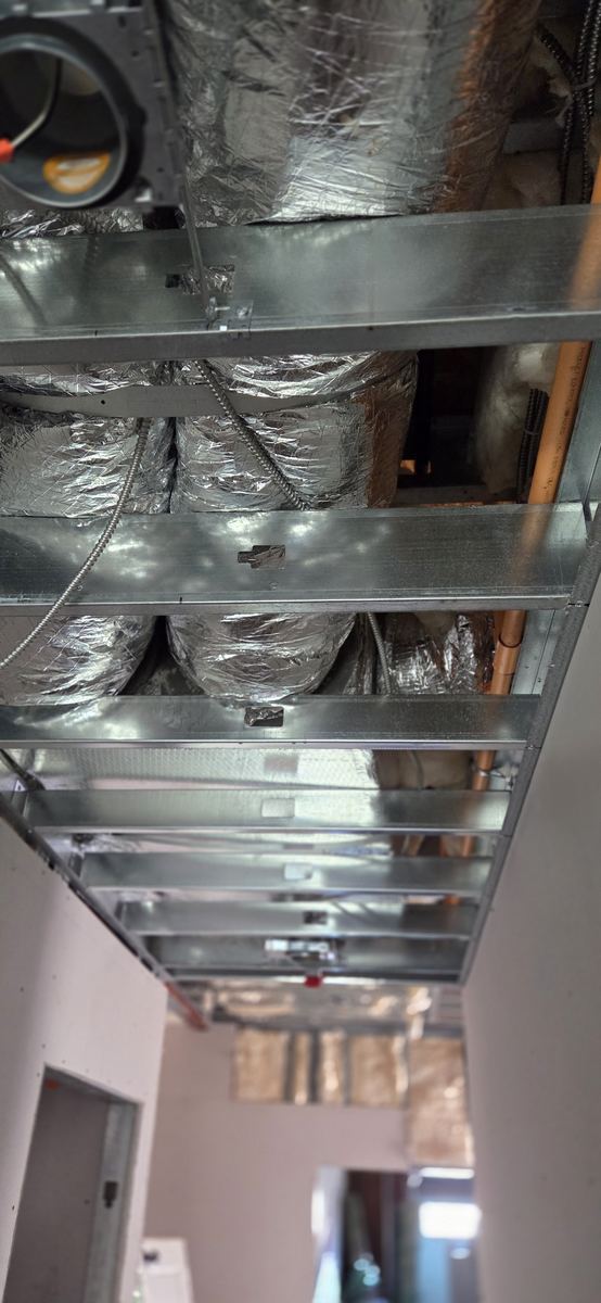 Ceiling grid coordinated around mechanical services.