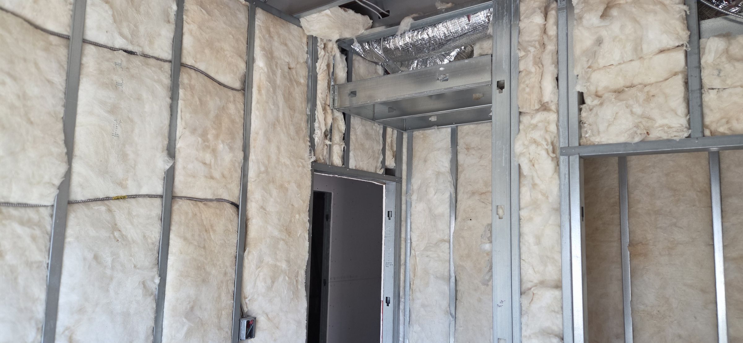 Insulated partition framed up to a new opening