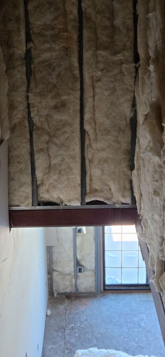 Insulation packed to the steel beam line.