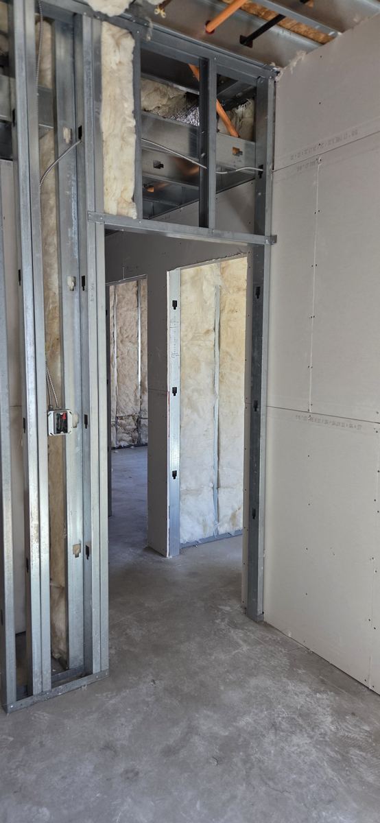 Light-gauge partitions laid out across an open commercial floor.