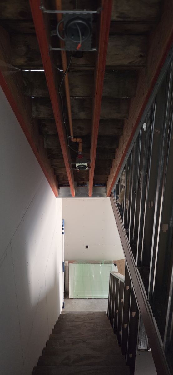 Structural steel left exposed above a finished floor.