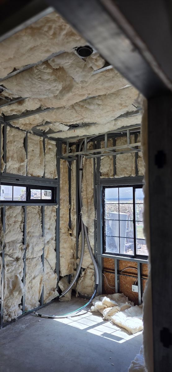 Steel and insulation above a glazed elevation.